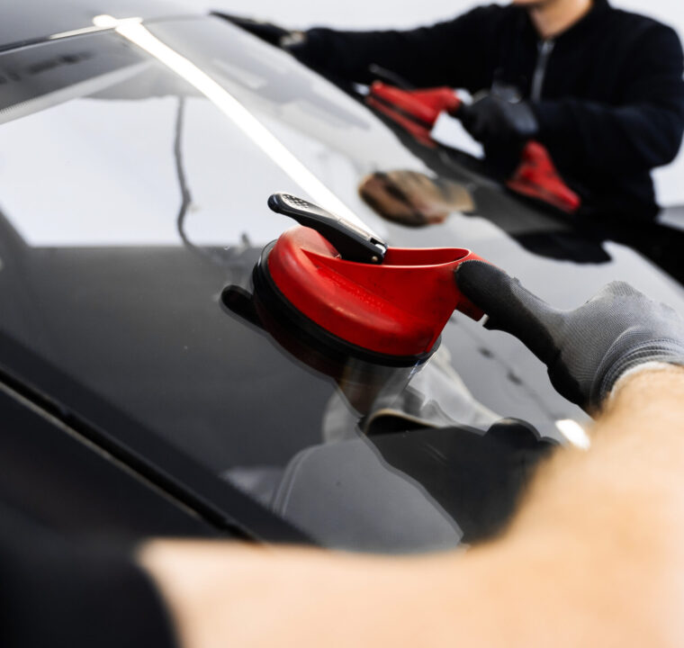 two-techs-lift-and-position-windshield-using-sucti-2026-04-04-23-44-50-utc